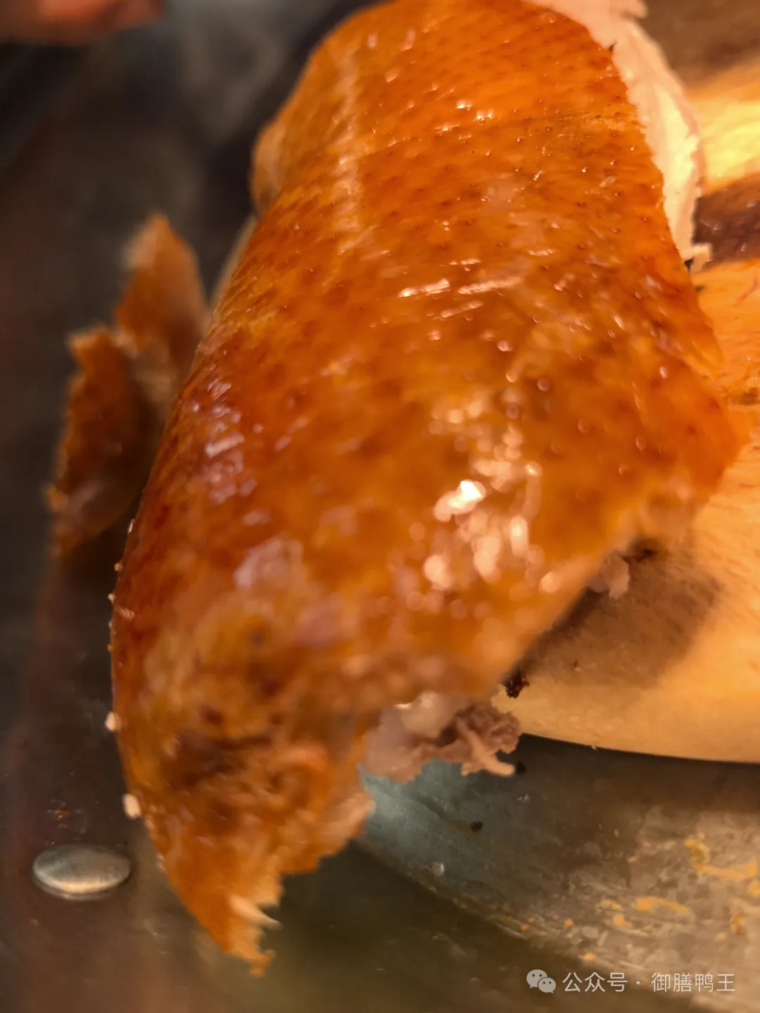 Close-up of finished roast duck skin and carved meat.
